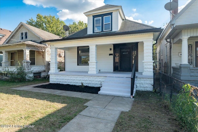 bungalow featuring a front yard and a porch