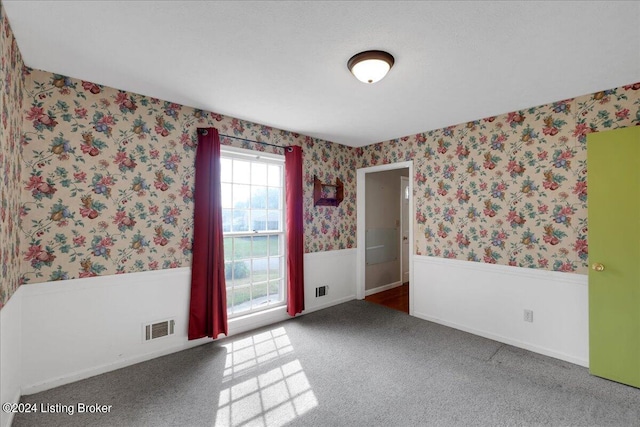 unfurnished room featuring carpet flooring