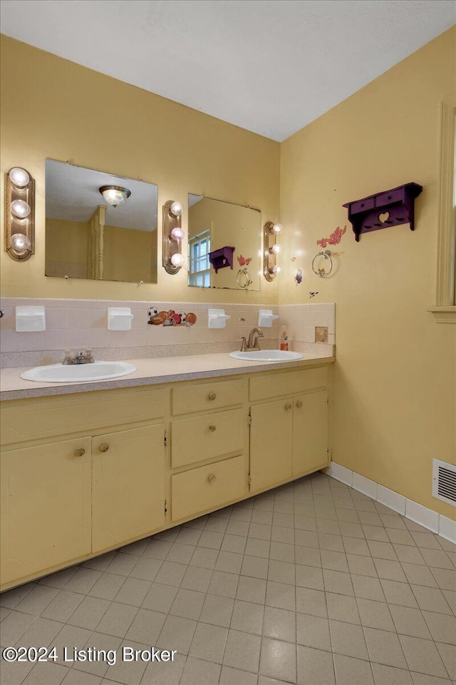 bathroom with vanity, tasteful backsplash, and tile patterned flooring