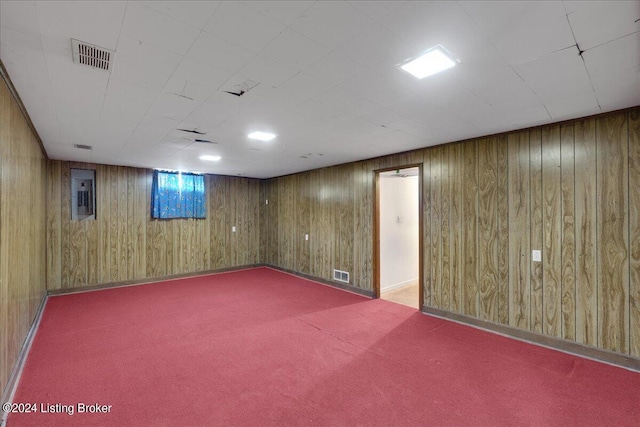 basement featuring wooden walls and carpet floors