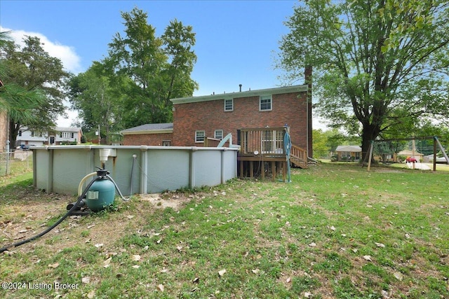 back of property featuring a lawn and a pool side deck