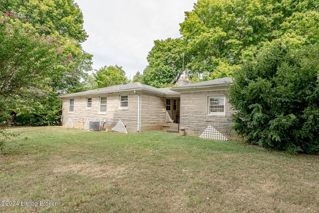 4626 Glen Rose Rd, Louisville, KY 40229 - rear view of property featuring stone siding, a chimney, a shingled roof, central AC, and a yard