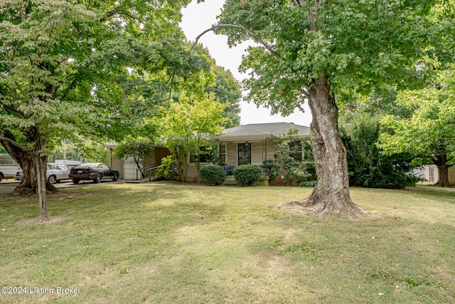 obstructed view of property featuring a front lawn