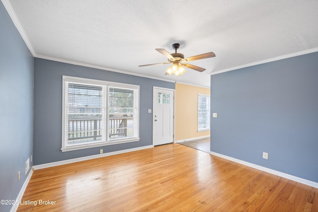 spare room featuring ceiling fan, crown molding, a textured ceiling, and light wood-type flooring