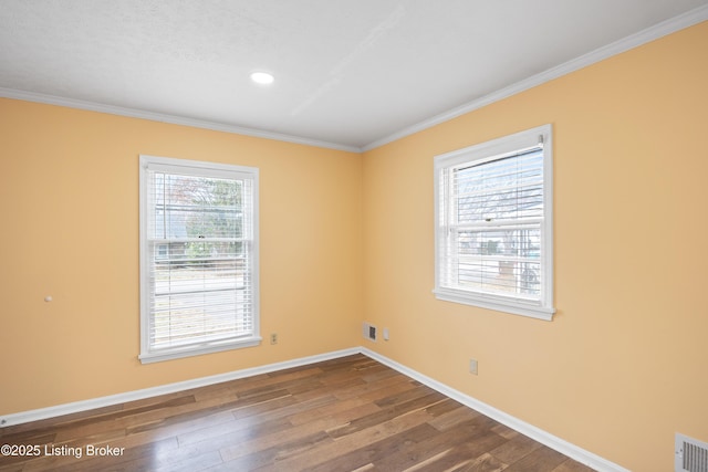 spare room featuring hardwood / wood-style flooring and crown molding