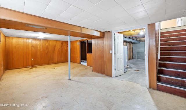 basement featuring wooden walls