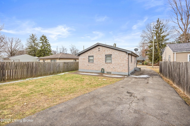 view of side of home featuring a yard