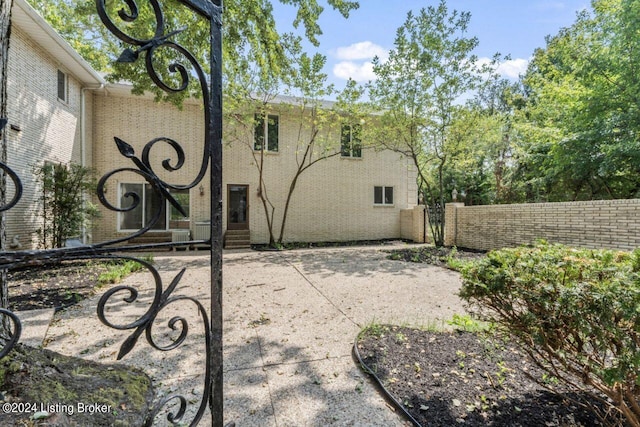 exterior space with brick siding and fence