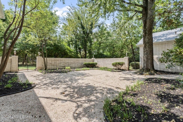 view of patio featuring a fenced front yard and a gate