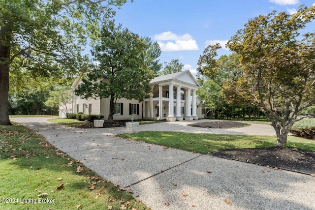 neoclassical home with a front lawn