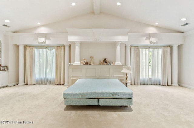 bedroom featuring light carpet, decorative columns, and visible vents