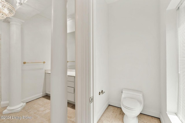 bathroom featuring tile patterned flooring, decorative columns, toilet, and baseboards