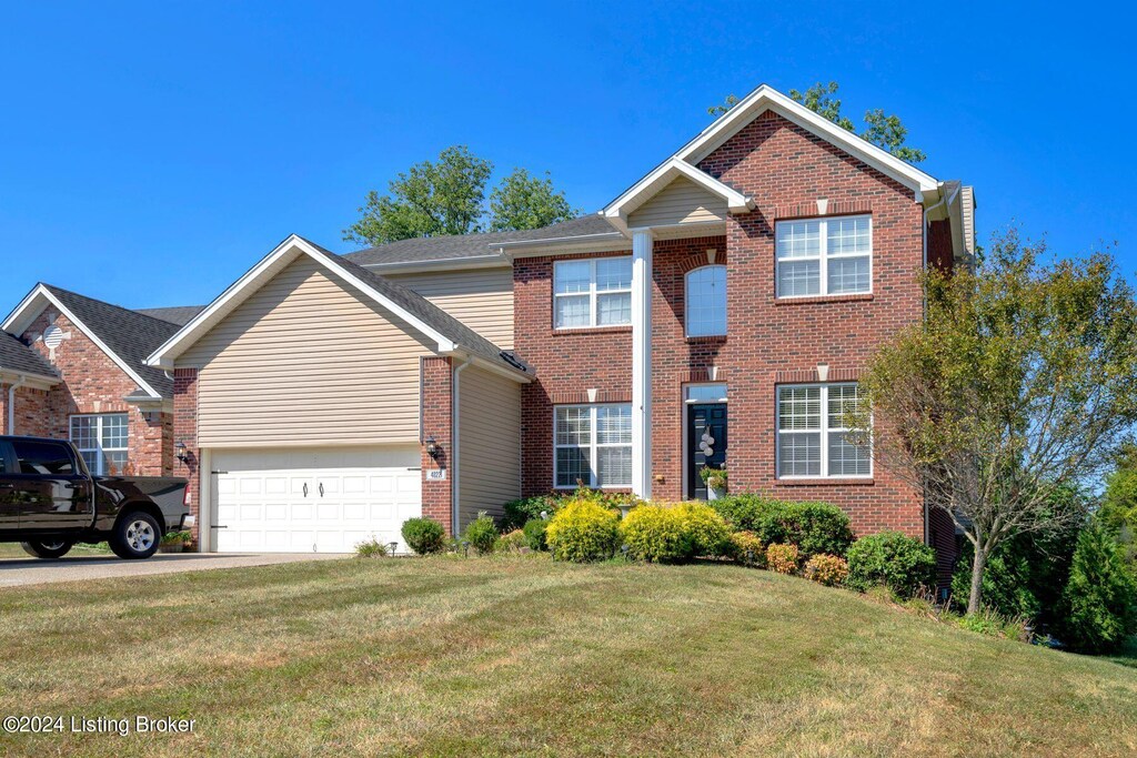 view of front property with a garage and a front yard