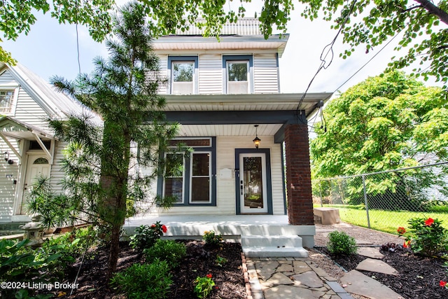 view of front of home with covered porch and fence