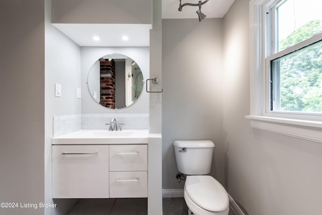 bathroom with tile patterned flooring, toilet, and vanity