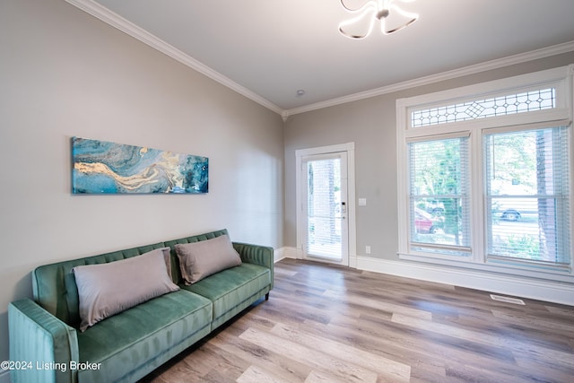 living room featuring ornamental molding, wood finished floors, visible vents, and baseboards