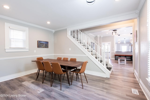 dining area with crown molding and wood-type flooring