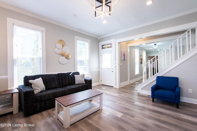 living room with wood-type flooring and ornamental molding