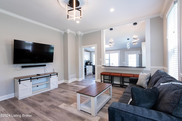 living room featuring ornamental molding, wood finished floors, and visible vents