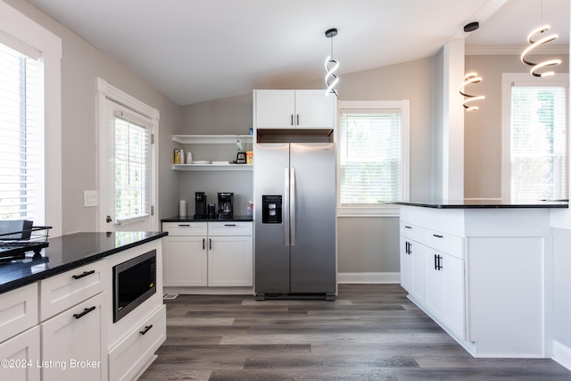 kitchen with a wealth of natural light, stainless steel appliances, dark hardwood / wood-style floors, and decorative light fixtures