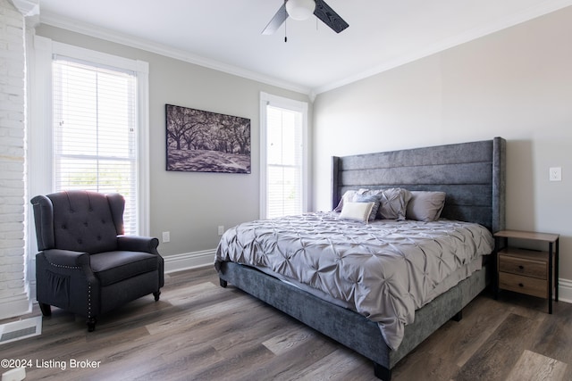 bedroom featuring ornamental molding, dark wood-type flooring, and ceiling fan