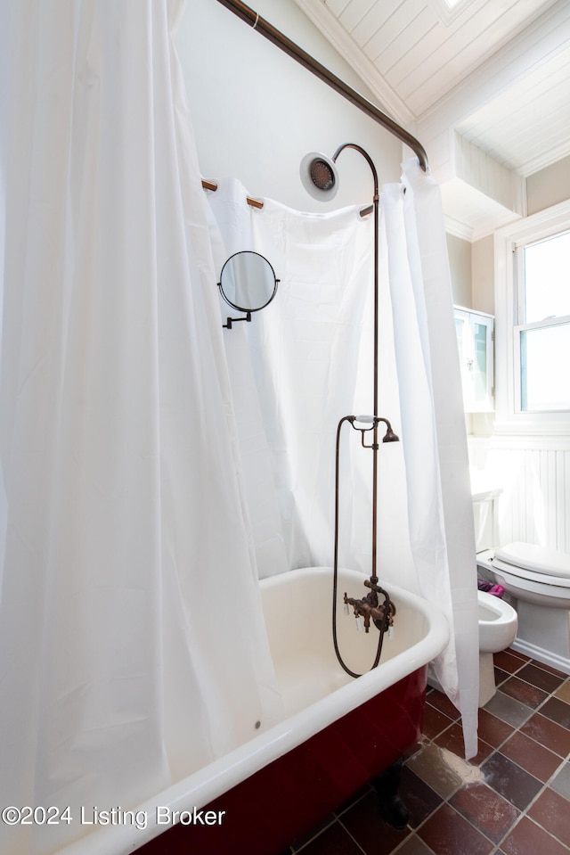 bathroom with lofted ceiling, toilet, and ornamental molding