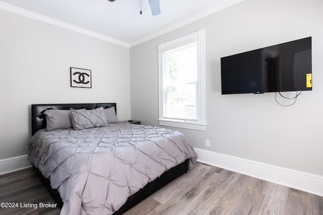 bedroom featuring crown molding, ceiling fan, and wood-type flooring