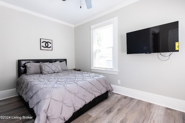 bedroom with ornamental molding, ceiling fan, baseboards, and wood finished floors