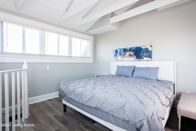 bedroom featuring dark hardwood / wood-style flooring and lofted ceiling with beams