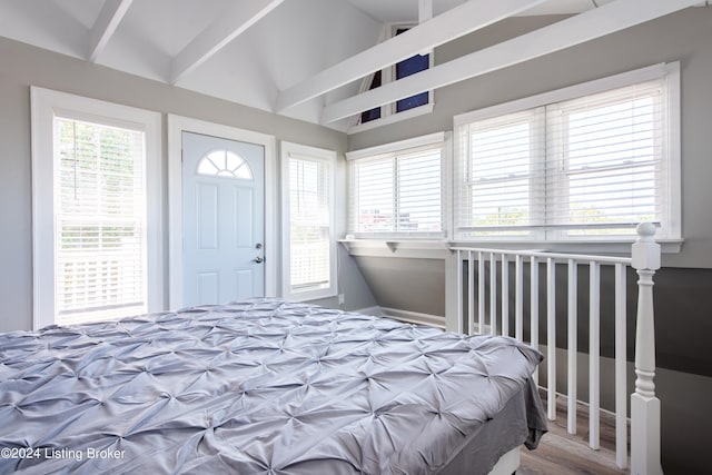 bedroom with hardwood / wood-style floors and lofted ceiling with beams