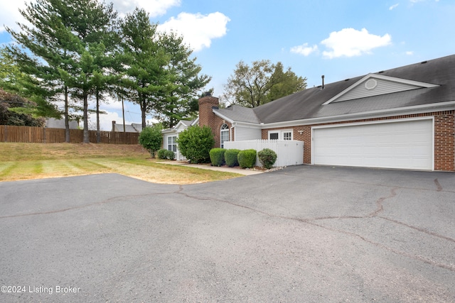 view of front of home featuring a front yard and a garage