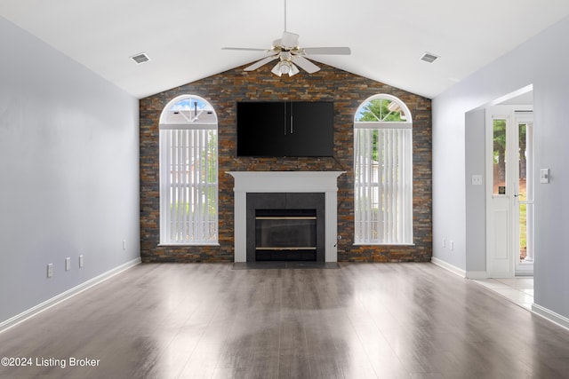 unfurnished living room with ceiling fan, plenty of natural light, wood-type flooring, and vaulted ceiling