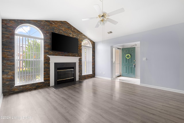 unfurnished living room with lofted ceiling, ceiling fan, and light wood-type flooring