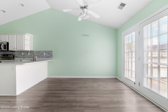 kitchen featuring sink, ceiling fan, appliances with stainless steel finishes, lofted ceiling, and white cabinets