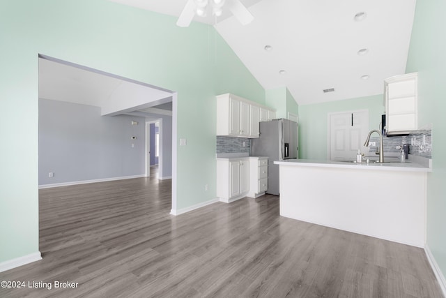 kitchen with light hardwood / wood-style flooring, ceiling fan, decorative backsplash, and white cabinets