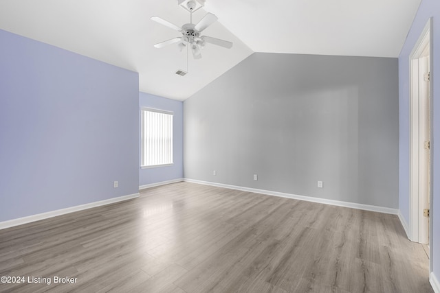 unfurnished room with light hardwood / wood-style flooring, ceiling fan, and vaulted ceiling