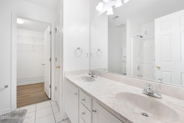 bathroom featuring vanity, a shower, and wood-type flooring