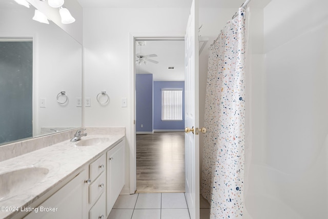 bathroom with tile patterned floors, ceiling fan, curtained shower, and vanity