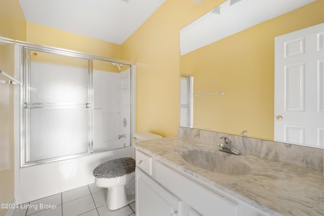 full bathroom featuring shower / bath combination with glass door, vanity, toilet, and tile patterned floors