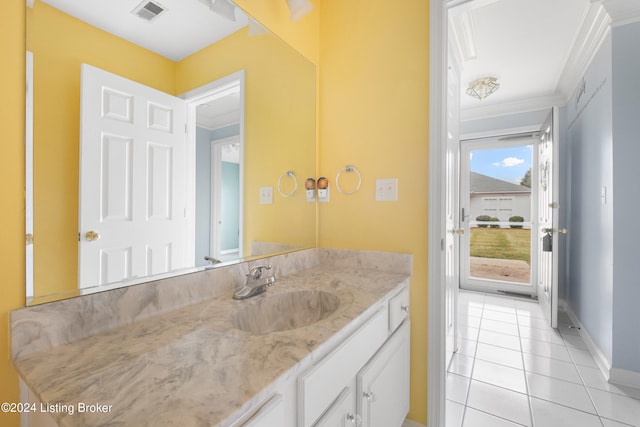 bathroom with tile patterned floors, ornamental molding, and vanity