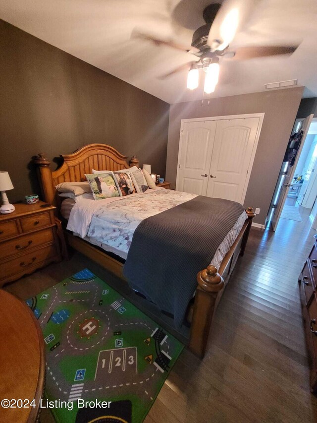 bedroom with a closet, ceiling fan, and dark wood-type flooring