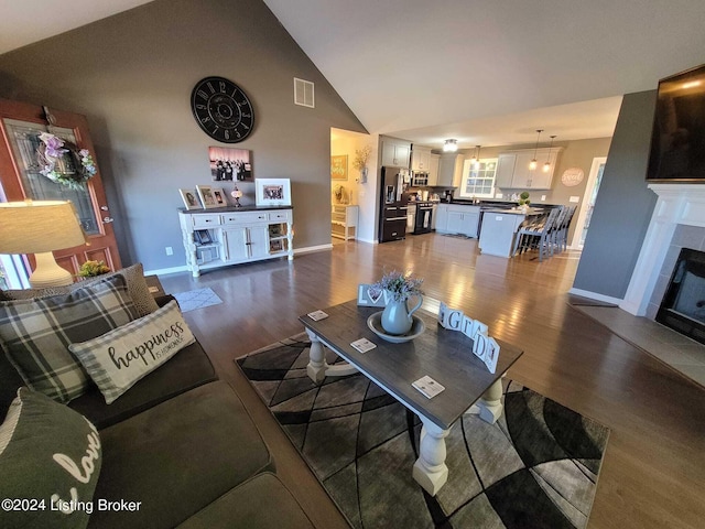 4 N Ridge View Dr, Carrollton, KY 41008 - living room with visible vents, baseboards, dark wood-style flooring, high vaulted ceiling, and a tile fireplace