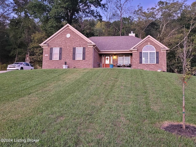 ranch-style house featuring a front yard