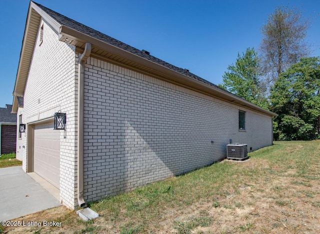 view of side of home with central AC and a garage