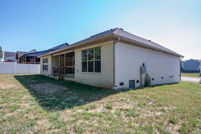 back of house with a yard