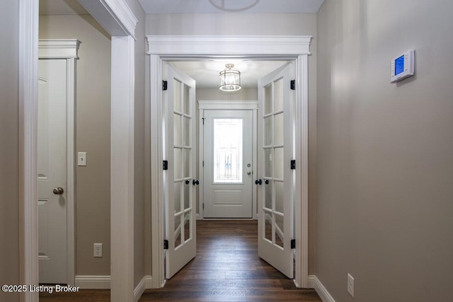 corridor featuring dark hardwood / wood-style floors and french doors