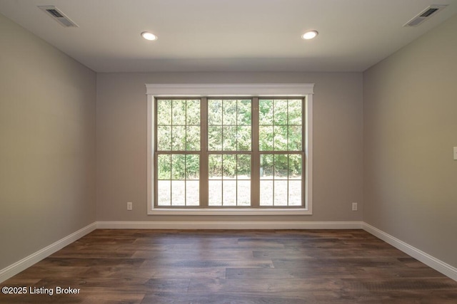 spare room with dark hardwood / wood-style floors