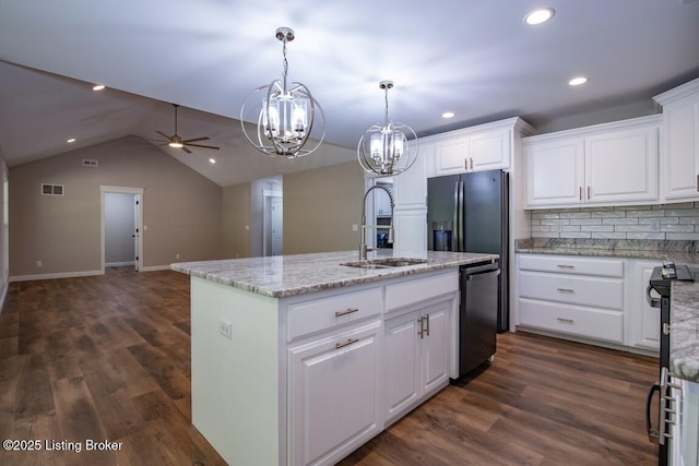 kitchen with sink, hanging light fixtures, a center island with sink, stainless steel appliances, and white cabinets