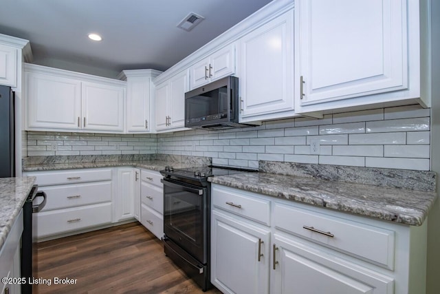 kitchen featuring light stone counters, decorative backsplash, black appliances, and white cabinets