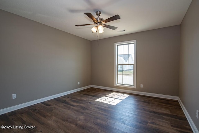 spare room with ceiling fan and dark hardwood / wood-style flooring